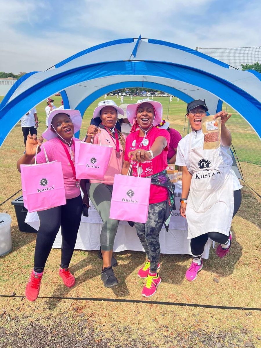 Guests celebrating with Kusta's gift bags at a community wellness activation
