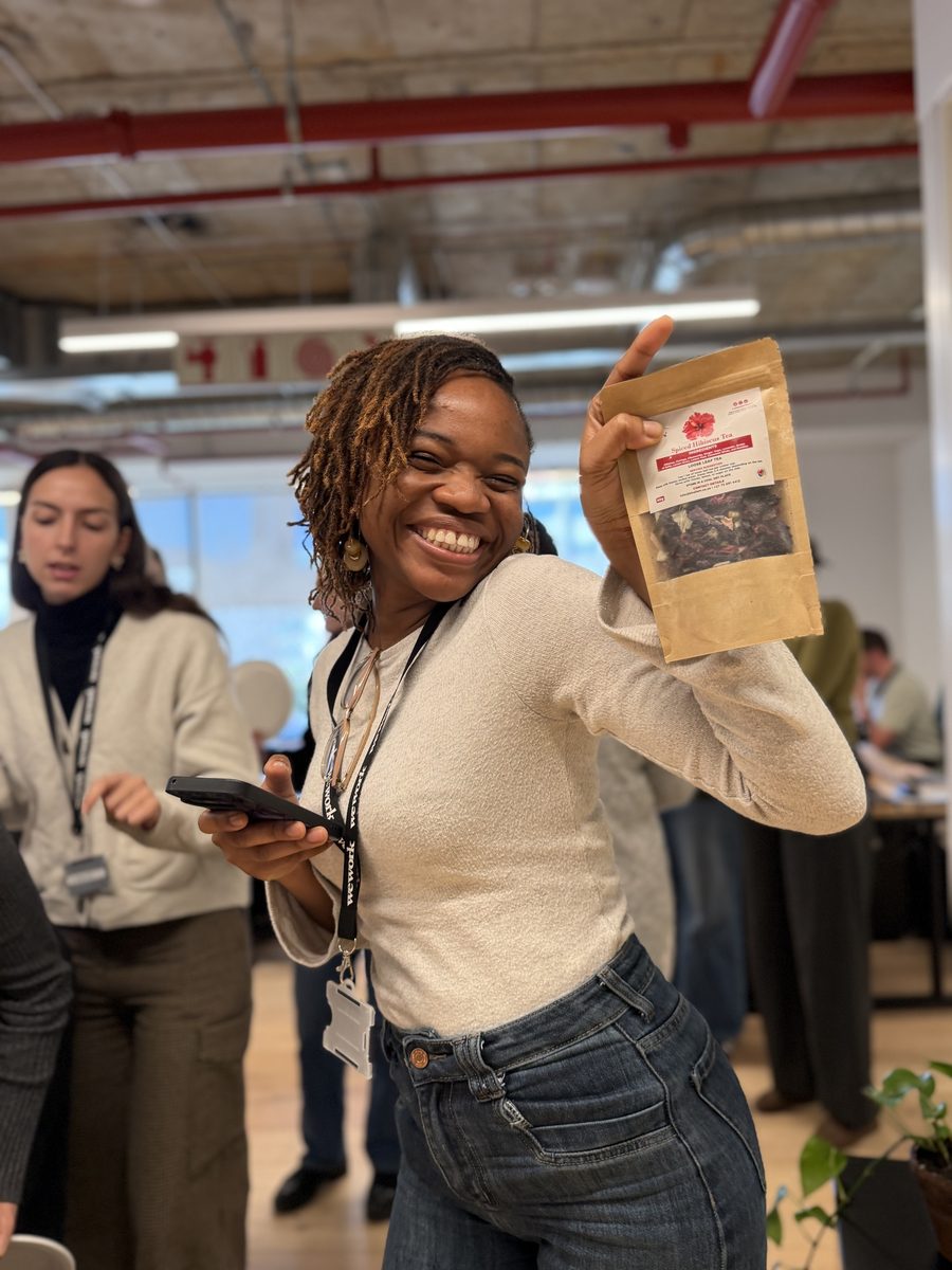 A guest enjoying Kusta's Spiced Hibiscus Tea at the Emzingo student gathering
